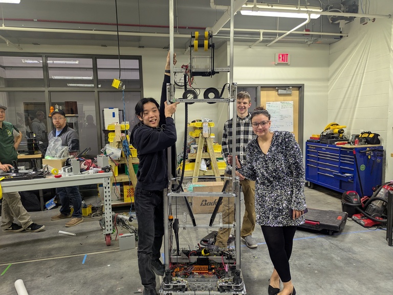 Jinann Abudagga and team with their robot for FRC 2025.