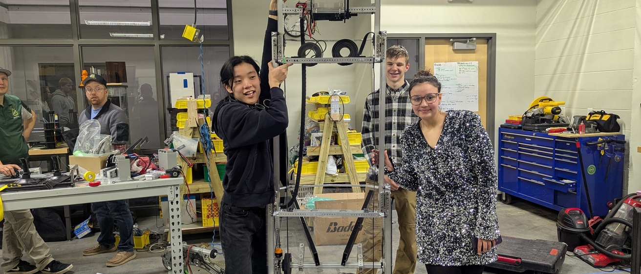 Jinann Abudagga and team with their robot for FRC 2025.