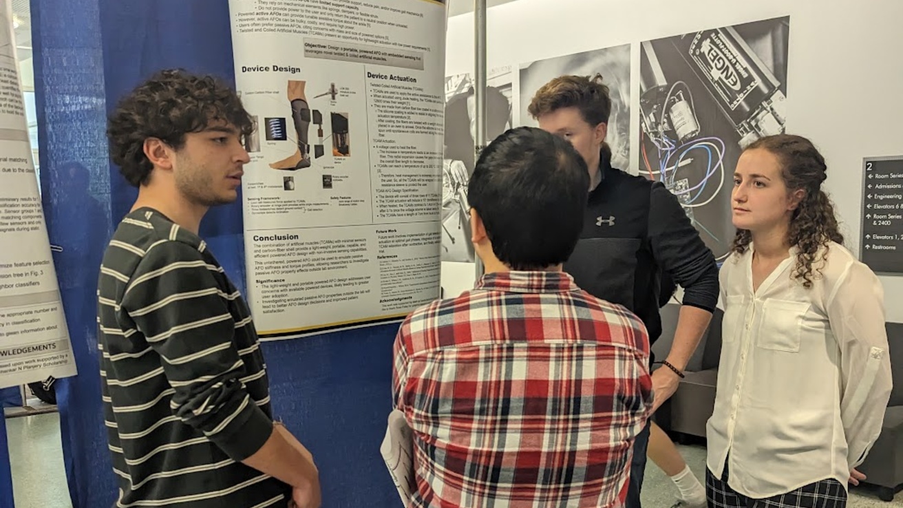 Students talking during research open house