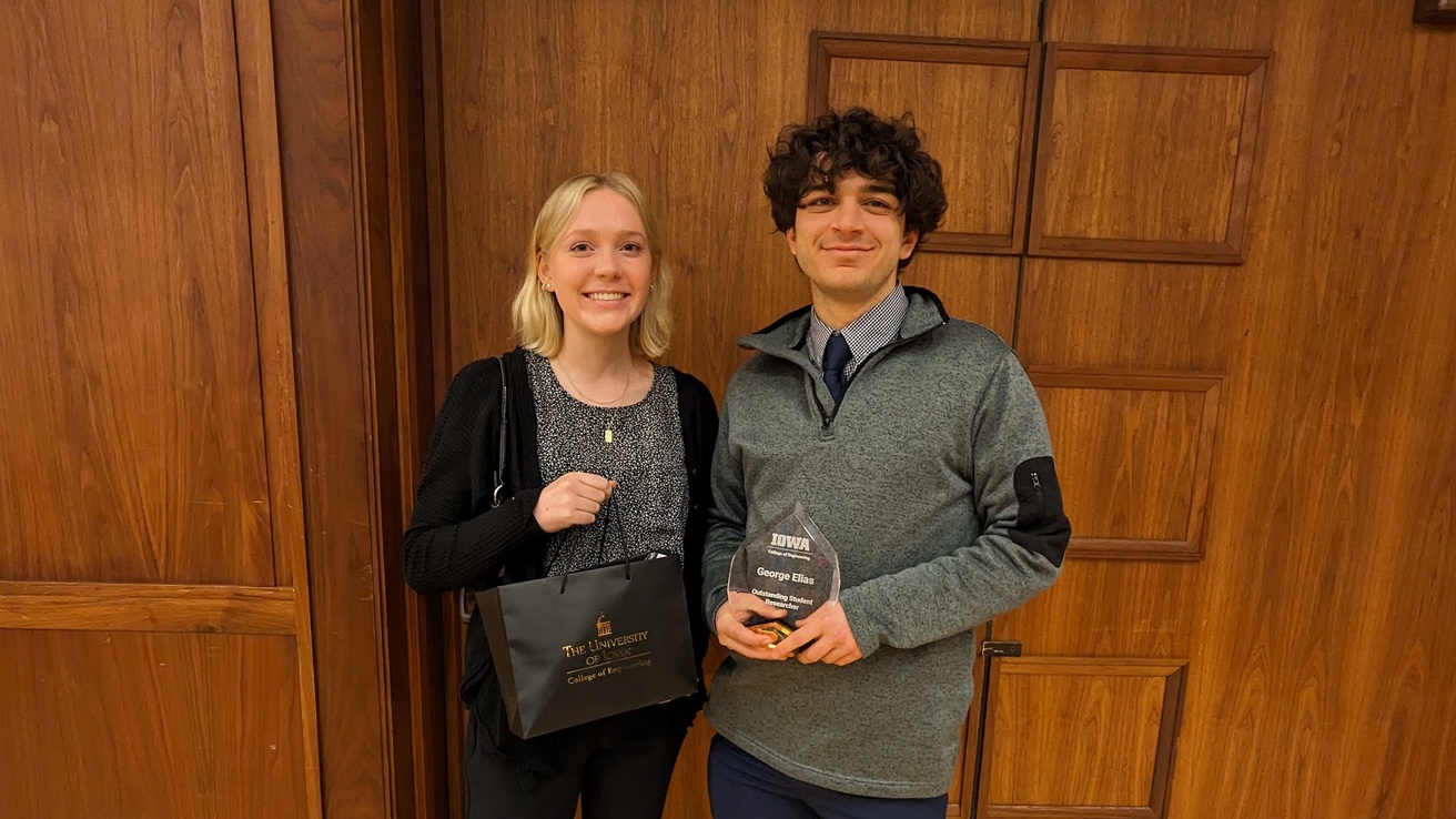 Katie and George smiling holding accepted student awards